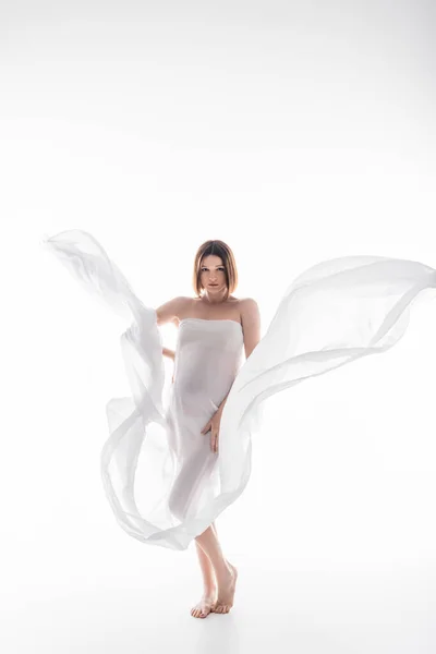 Pregnant woman in cloth posing while standing on grey background — Stock Photo