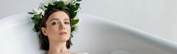 Young woman in wreath taking bath in bathroom, banner — Stock Photo