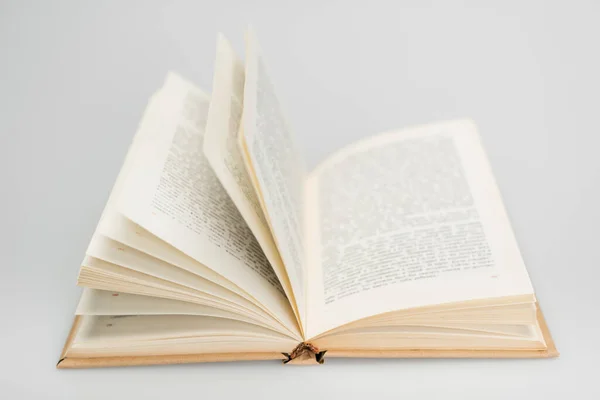 Open book with text on grey blurred background — Stock Photo