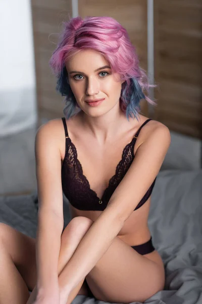 Portrait of young woman in dark sexy lingerie looking at camera — Stock Photo