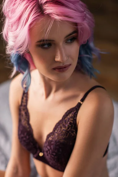 Portrait of young woman in dark bra looking away — Stock Photo