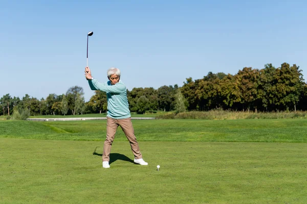 Full length of asian senior man playing golf — Stock Photo