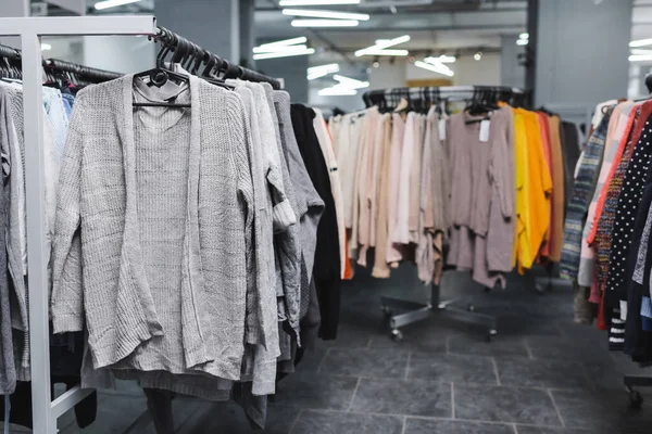 Jumpers and sweaters on hangers in second hand — Foto stock