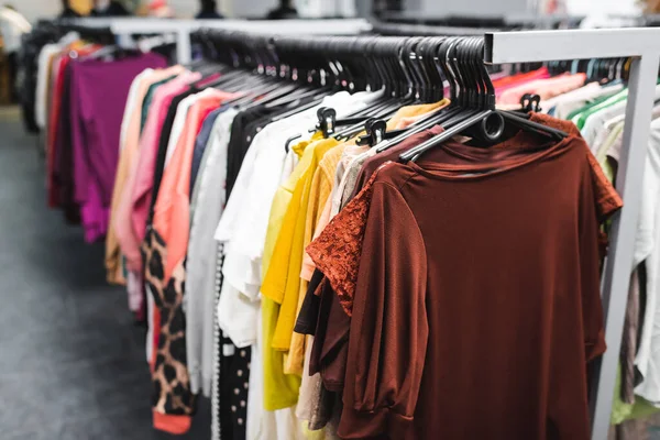 T-shirts near clothing in second hand — Stock Photo