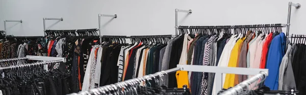 Vintage clothing on hangers in vintage shop, banner — Stock Photo