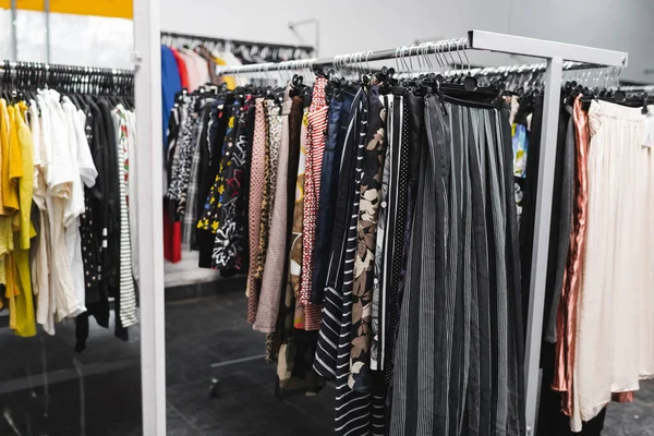 Pants on hangers in blurred vintage shop — Stockfoto