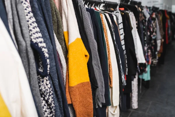 Sweaters on hangers in retro shop — Stockfoto