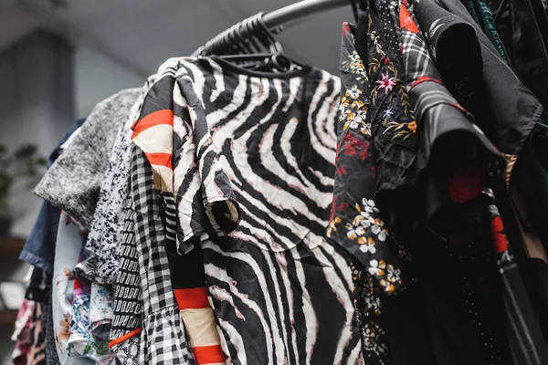 Low angle view of vintage blouses on hangers in vintage shop — Stockfoto