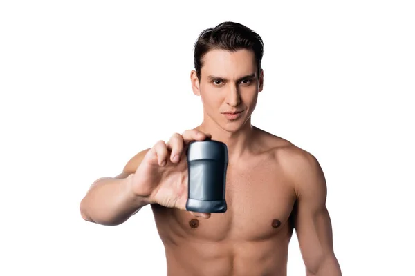 Brunette man with perfect body holding dry deodorant isolated on white — Stock Photo
