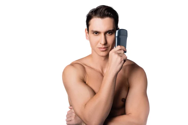 Positive shirtless man holding antiperspirant and looking at camera isolated on white — Stock Photo