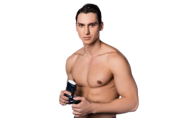 Muscular shirtless man with antiperspirant looking at camera isolated on white — Stock Photo