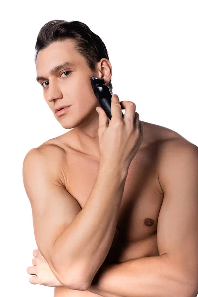 Brunette man with perfect skin shaving and looking at camera isolated on white — Stock Photo