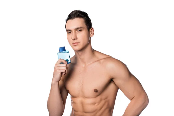 Uomo muscoloso senza maglietta con fiala di profumo guardando telecamera isolata su bianco — Foto stock