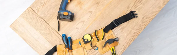 Top view of tool box with tools and electric screwdriver on table, banner — Foto stock