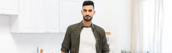 Young muslim man looking at camera at home, banner — Stockfoto