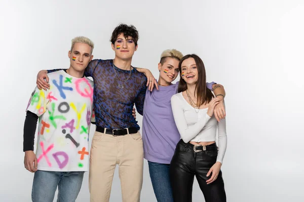 Young lgbtq community friends looking at camera while embracing isolated on grey — Stockfoto