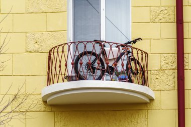 Bicycle on the balcony of a multi-storey building. The picture was taken in Russia, in the city of Orenburg