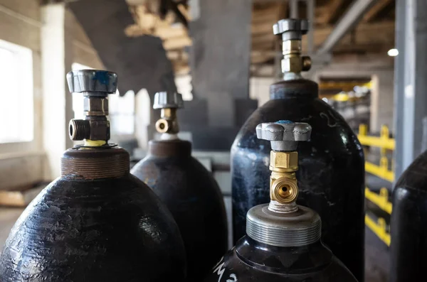 Compressed gas cylinders in the production room of an industrial plant. The picture was taken in Russia