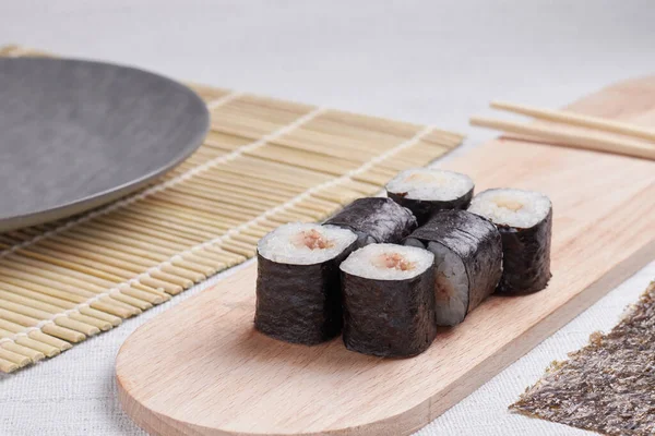 Bir porsiyon ekmek, Japon yemeği, masada suşi, Çin yemek çubukları, hafif arka plan.