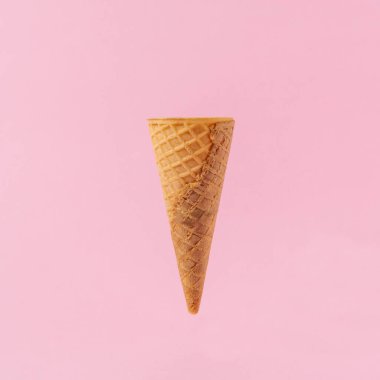 Ice cream cone on a light pink background.