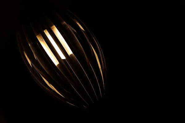 Lámpara Metal Colgante Iluminada Forma Avellana Sobre Fondo Negro —  Fotos de Stock