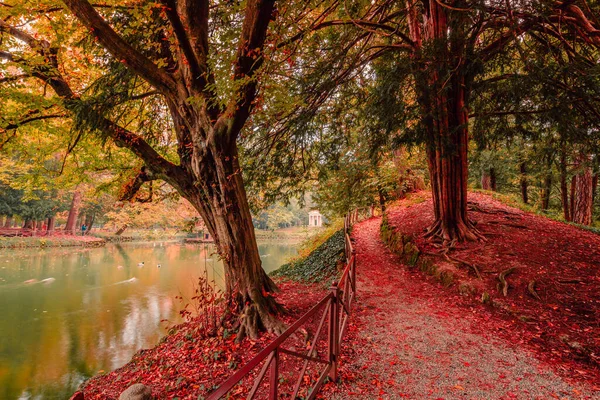 2021年11月 意大利蒙扎 蒙扎公园的小池塘周围的土路 背景为秋叶时期的新古典主义神庙 — 图库照片