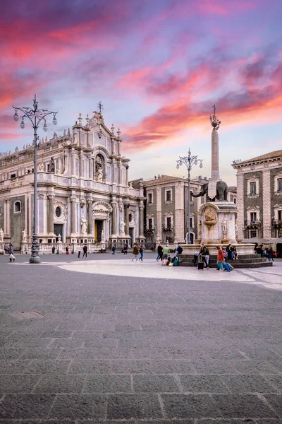 Catania, Italy - March 2022: Piazza Duomo of Catania with its cathedral and the elephant fountain, symbols of the city, during a sunset