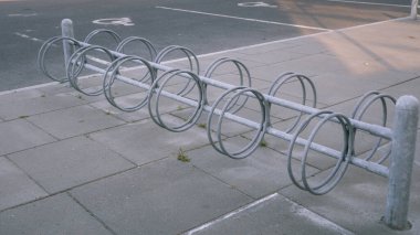 Empty metal parking for bicycles in a public place. Restrictions during quarantine. Equipment for parking bicycles on the street at the entrance to the park, free spaces.