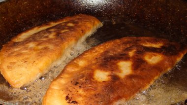 Yemek pişirmek. Chebureks pişiriyorum. Hamurda kızarmış et. Ulusal bir yemek. Cheburek, etli ve soğanlı kızarmış turta. Geleneksel Türk ve Moğol yemeği, börekler börek böreği