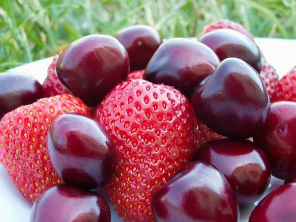 Berry mix. Strawberries and cherries on a white background. Fresh organic summer berries mix in white plate