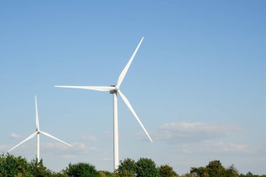 Wind turbines. Wind turbines generating electricity with blue sky - renewable energy concept. Wind turbines against blue sky
