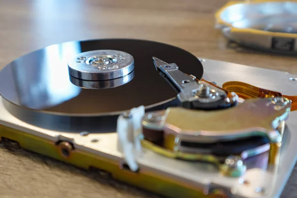 Disassembled computer hard drive. Repair broken computer part, close up of open hard disc drive hdd. Disassembled hard drive from the computer, hdd with mirror effect.