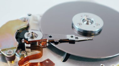 Disassembled computer hard drive. Repair broken computer part, close up of open hard disc drive (hdd). Hdd with mirror effect.