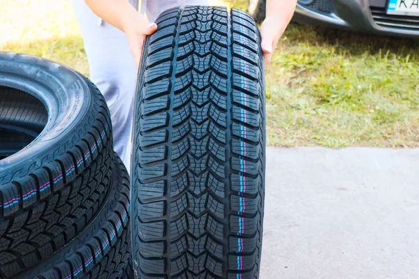 Woman Putting Hand New Wheel Tire Female Holding Tire Standing — стоковое фото