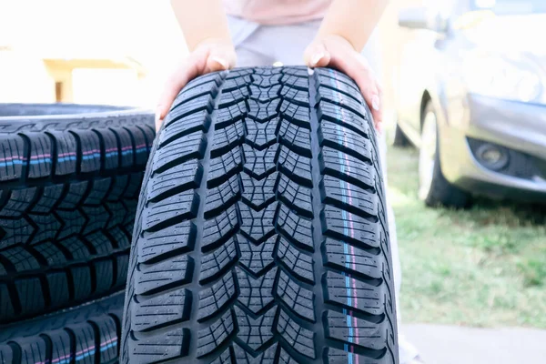 Woman Putting Hand New Wheel Tire Female Holding Tire Standing — стоковое фото