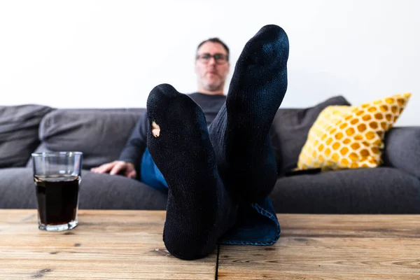 Man Hole His Sock Sitting Couch Royalty Free Stock Images
