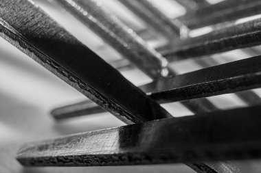 crossed metal forks photographed very close
