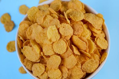 cornflakes in a shelf on a blue background top view