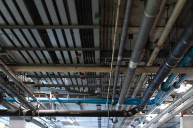 Mechanical and electrical and pipe services on the ceiling in a construction site.