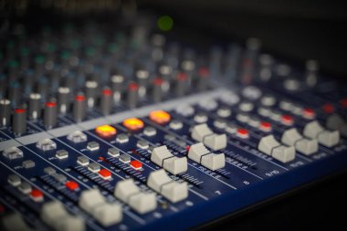 Men's hands are controlling the console of a large hi-fi system.with flair light
