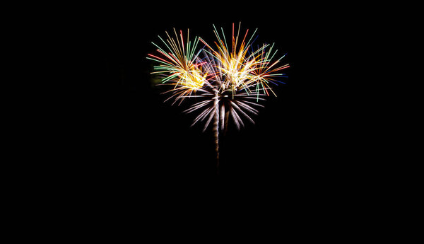 Festive fireworks on black background. Colorful celebration. Copy space.