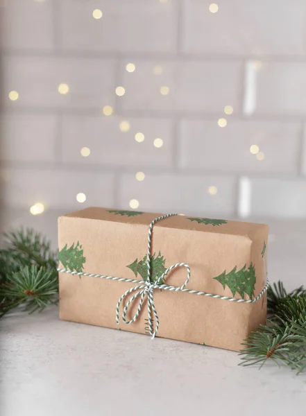 Christmas Gifts minimalism wrapping with lights of garland, Fir Branches on grey Background — Foto Stock