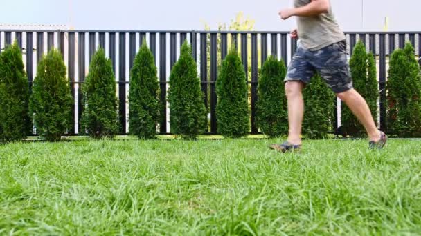 Man plays with his beagle dog outdoors and treats her pet with a treat. Teases his puppy with his favourite toy. Slow Motion — Stock Video