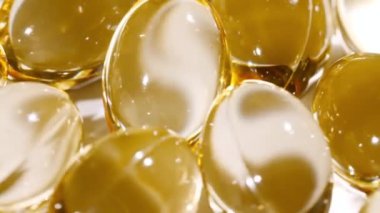 Sarı yağ kapsüllerinin makro görüntüsü, C vitamini, Omega 3, yakın çekim. Haplar ve uyuşturucular. İlaç Endüstrisi. Tıp konsepti. Yavaş çekim