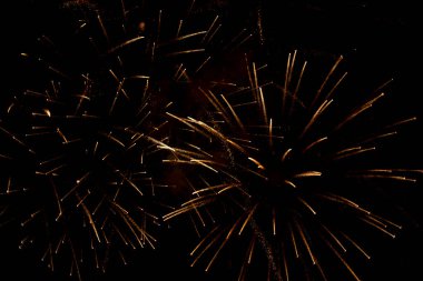 Gökyüzünde selam dur. Gece gökyüzünde havai fişek patlaması. Kestane fişekleri karanlık bir uzayda kıvılcımlar saçıyor. Havai fişekler. Yanan baruttan kıvılcımlar saçan arkaplan.