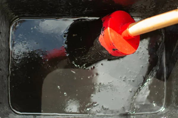 Pinsel Mit Schwarzer Farbe Pinsel Einem Behälter Mit Wasserdichter Farbe lizenzfreie Stockfotos