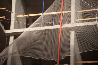 İnşaat alanında güvenlik ağı. Düşmeye karşı eskrim. Binanın etrafındaki iskeleye. Ev inşaatının ayrıntıları.