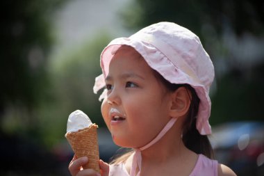 Bir çocuk dondurma yer. Kız tatlılığı ısırıyor. Çocuğun elinde yaz dondurması. Panama 'da bir anaokulu öğrencisi. Yazın sokakta dinlenin..