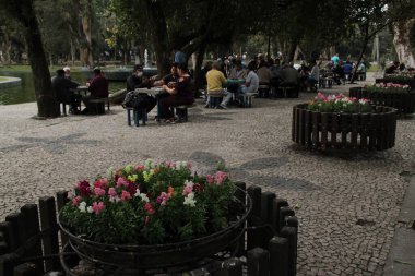 View and movement in Passeio Publico, the oldest in Curitiba. July 8, 2022, Curitiba, Parana, Brazil: View and movement at Passeio Publico, the oldest park in Curitiba, on Friday (8), in a sunny day in the capital of Parana.