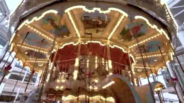 4k childrens carousel with horses in the evening — Stock Video